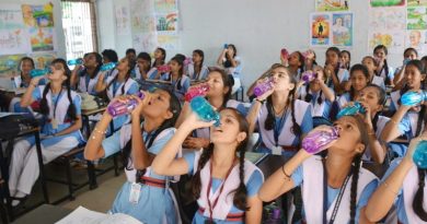children drinking water in class room